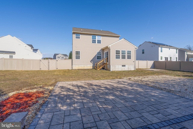 back of house with a yard and a patio