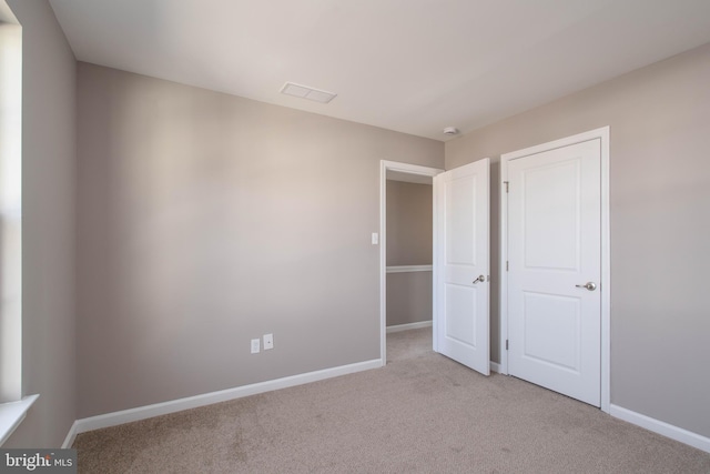 unfurnished bedroom featuring light colored carpet