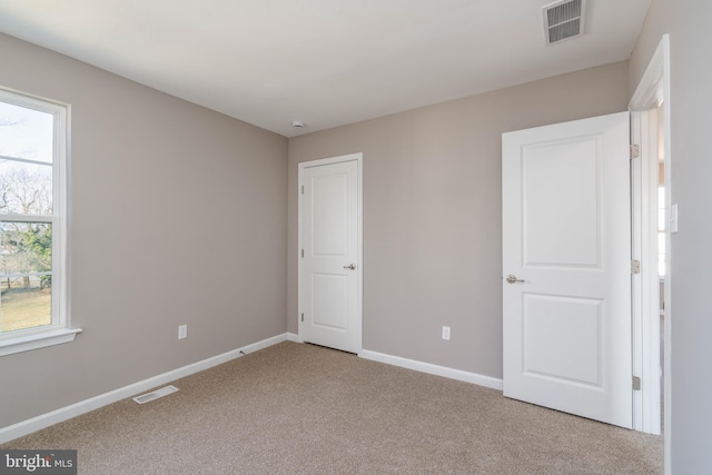 unfurnished bedroom featuring light colored carpet