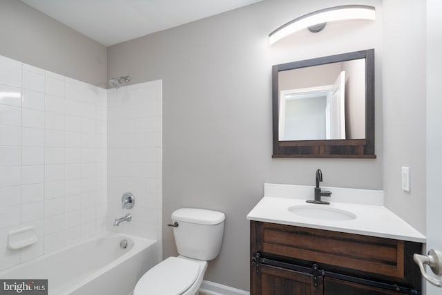 full bathroom featuring vanity, tiled shower / bath combo, and toilet