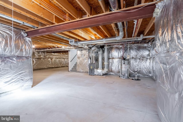 basement with water heater and heating unit