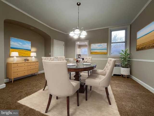 carpeted dining area featuring crown molding and a chandelier