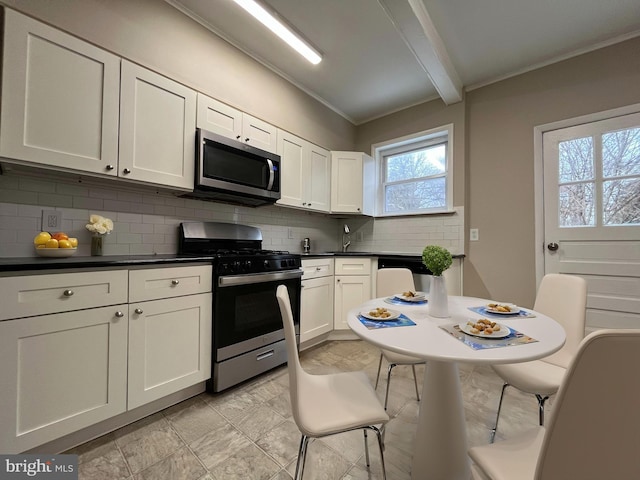 kitchen with ornamental molding, white cabinets, stainless steel appliances, beam ceiling, and backsplash