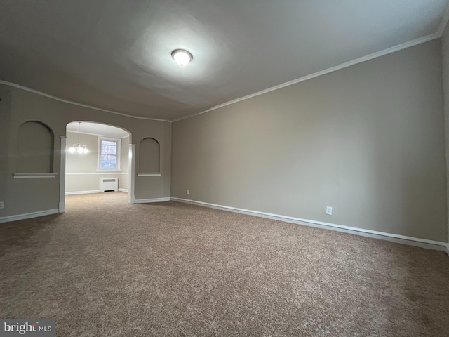 carpeted empty room featuring ornamental molding and a notable chandelier