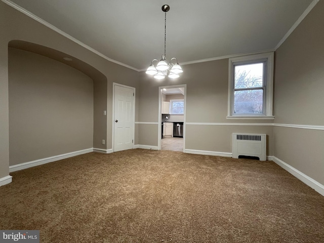 unfurnished dining area with crown molding, carpet floors, radiator heating unit, and a notable chandelier