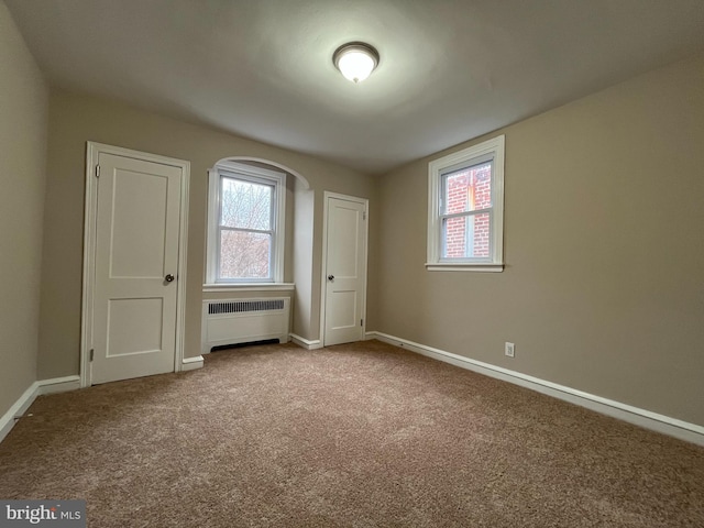 interior space with radiator and light colored carpet