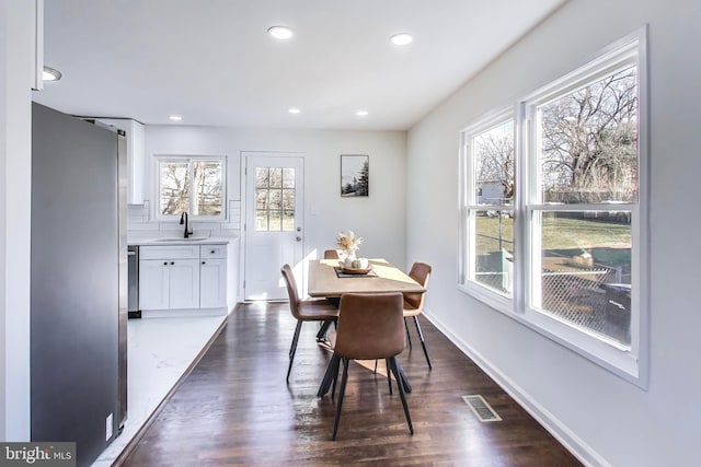 dining area with dark hardwood / wood-style flooring and sink