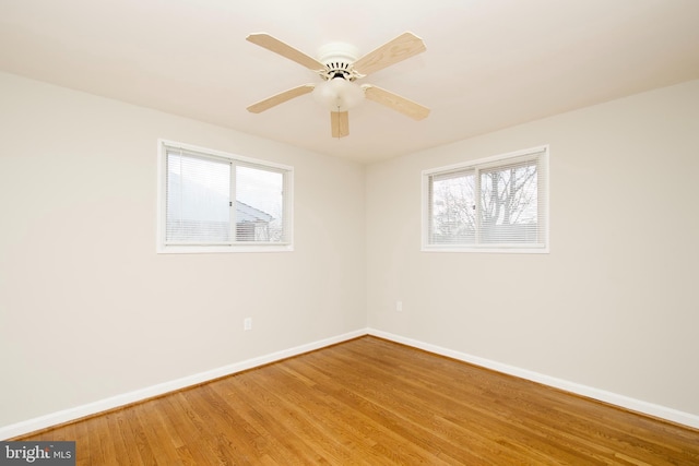 empty room featuring hardwood / wood-style flooring and ceiling fan