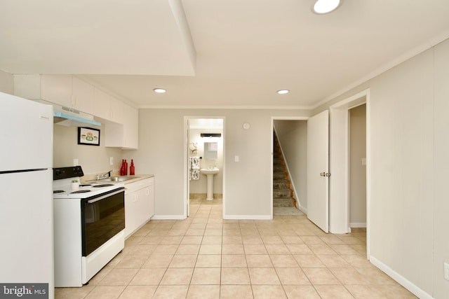 kitchen with light tile patterned floors, crown molding, white appliances, sink, and white cabinets