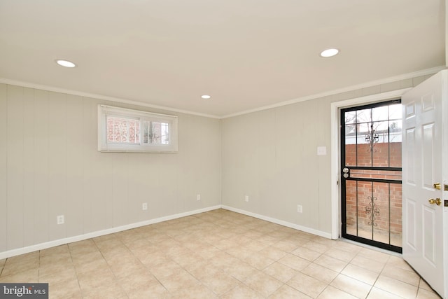 spare room featuring ornamental molding and light tile patterned floors