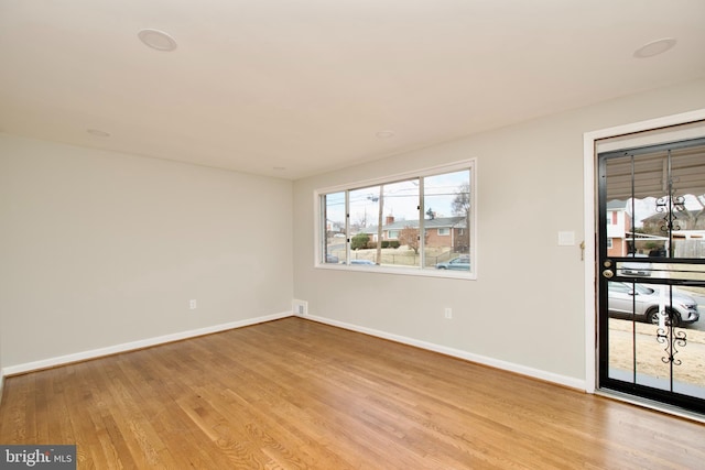 empty room with light hardwood / wood-style floors