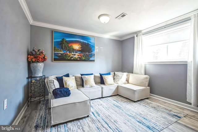 living area featuring ornamental molding, wood finished floors, visible vents, and baseboards