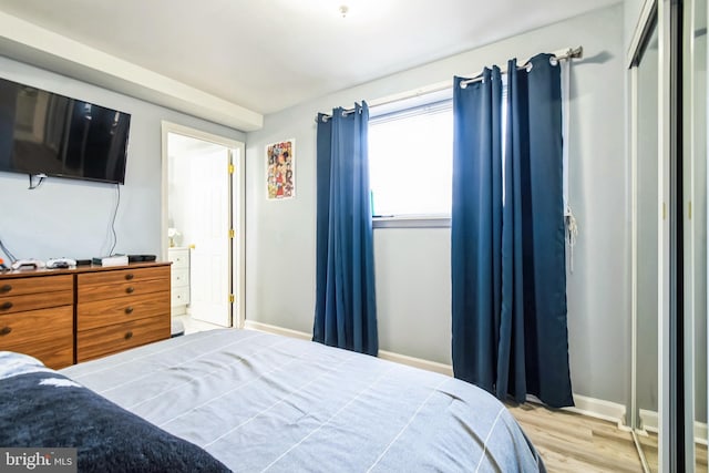 bedroom with baseboards and light wood-style floors