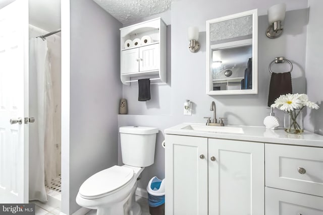 full bath with toilet, a textured ceiling, a shower stall, and vanity