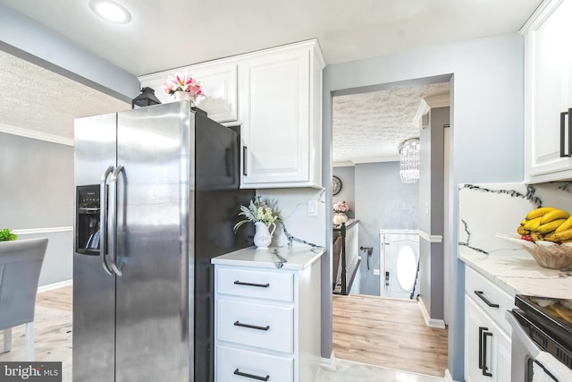 kitchen featuring stainless steel appliances, light wood-style floors, white cabinetry, and crown molding