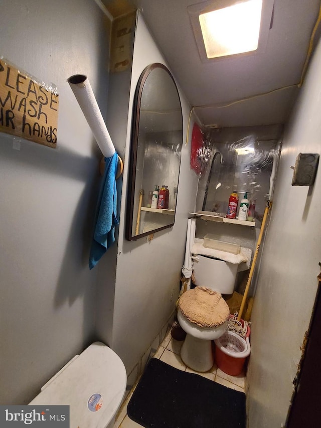 bathroom featuring tile patterned flooring and toilet