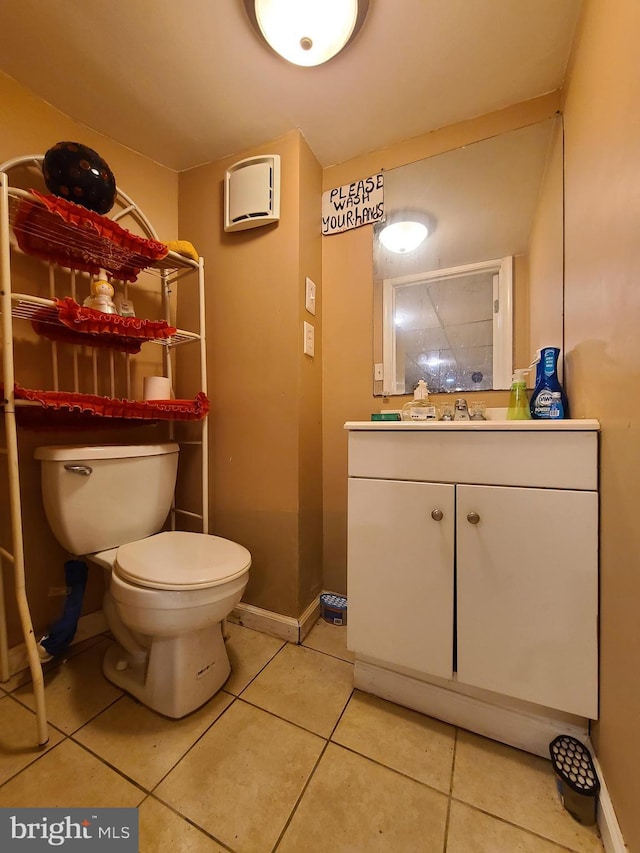 bathroom featuring vanity, tile patterned floors, and toilet