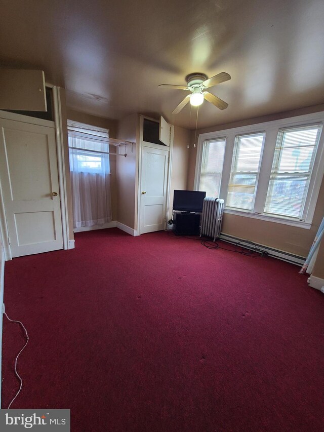 interior space with ceiling fan, a healthy amount of sunlight, and carpet