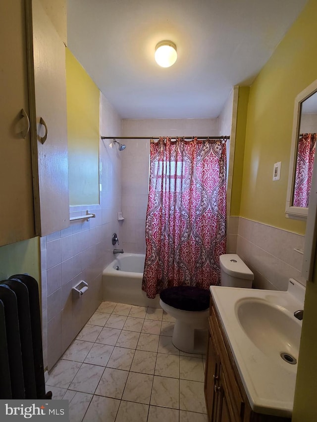 full bathroom with tile walls, vanity, radiator heating unit, and toilet