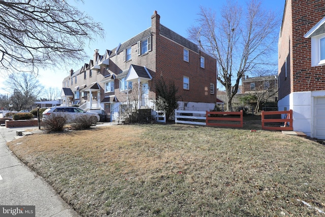 view of side of property with a yard