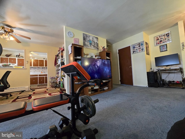 exercise area featuring a baseboard radiator, carpet, and ceiling fan