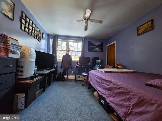 carpeted bedroom with ceiling fan and a baseboard radiator