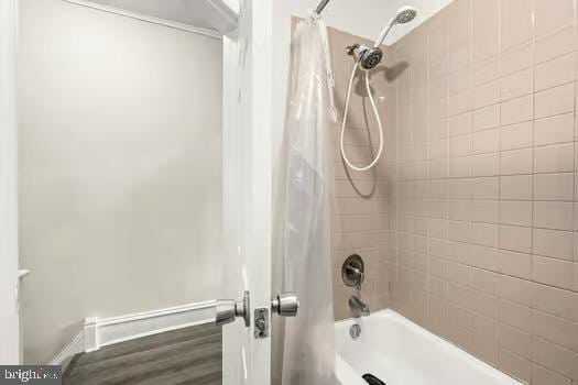 bathroom featuring hardwood / wood-style floors and shower / bath combination with curtain