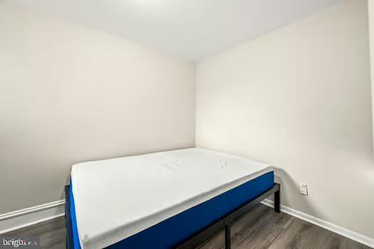 bedroom featuring dark wood-type flooring