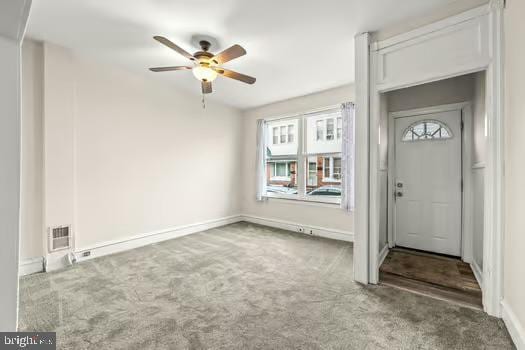 carpeted entryway featuring ceiling fan