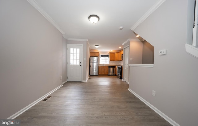 interior space featuring crown molding and wood-type flooring