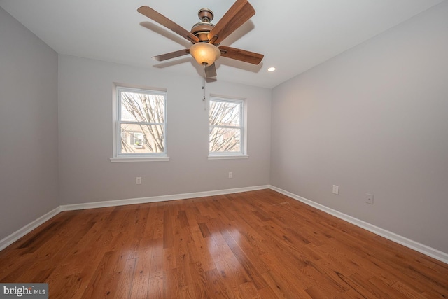 spare room with hardwood / wood-style flooring and ceiling fan