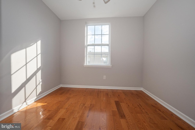 empty room with light hardwood / wood-style floors and ceiling fan