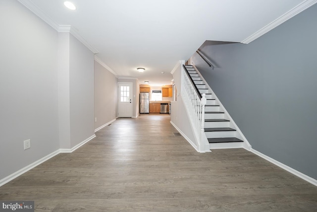 entrance foyer featuring crown molding and hardwood / wood-style floors