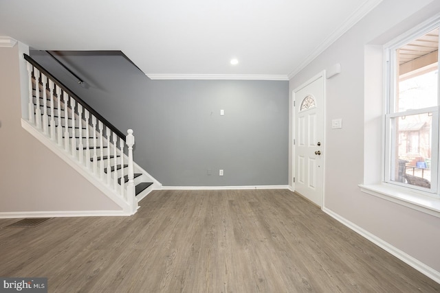 entrance foyer featuring wood-type flooring and ornamental molding