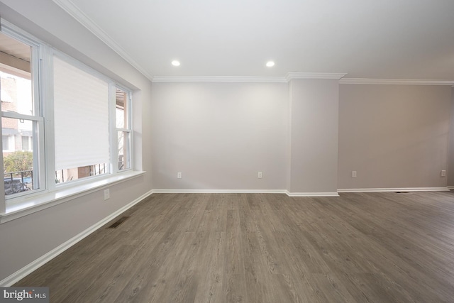 empty room featuring crown molding and dark hardwood / wood-style flooring