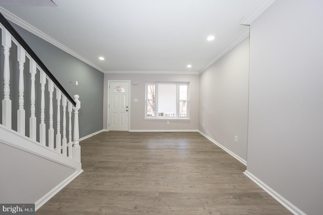 foyer with crown molding and wood-type flooring