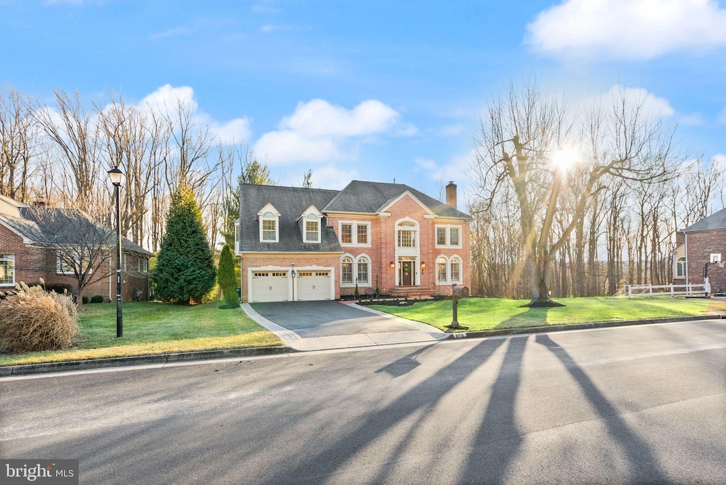 view of front of house with a garage and a front lawn