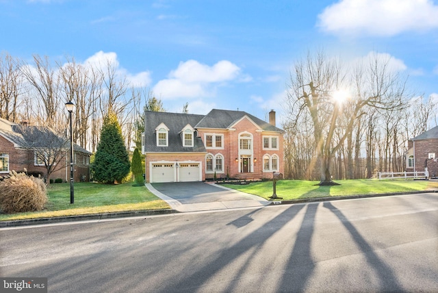 view of front of house with a garage and a front lawn