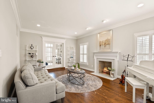 living room featuring crown molding, hardwood / wood-style floors, and french doors