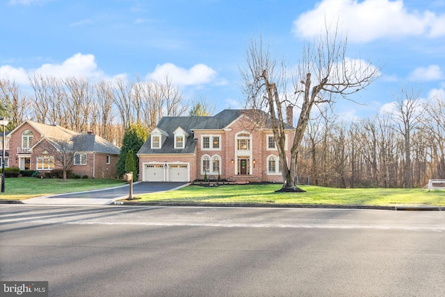 view of front of property featuring a garage and a front yard