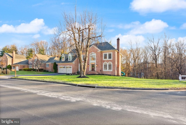 view of front facade with a garage and a front lawn