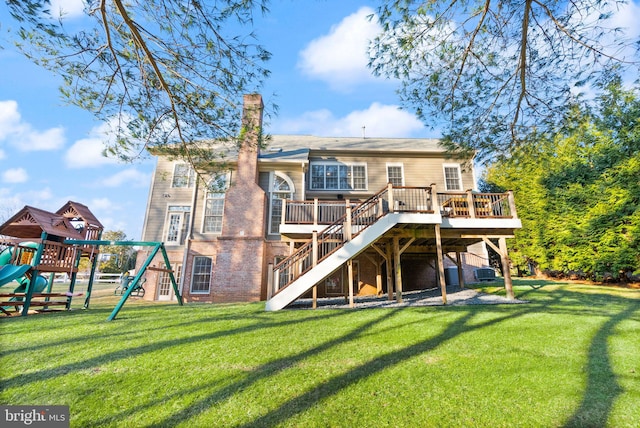 rear view of house featuring a yard, a playground, and a deck