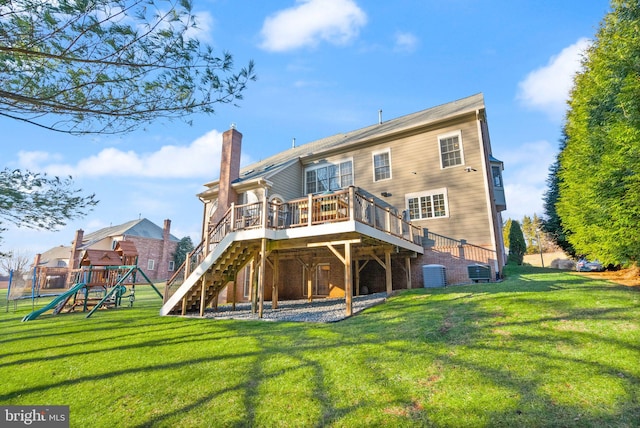 back of property featuring a playground, a wooden deck, central AC, and a lawn