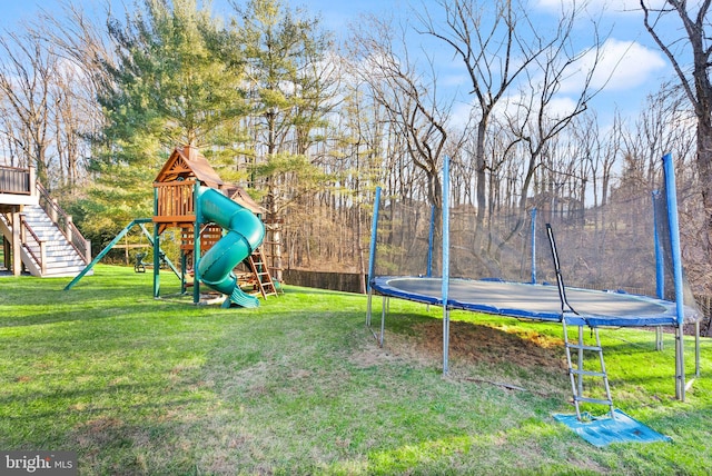 view of yard with a playground and a trampoline