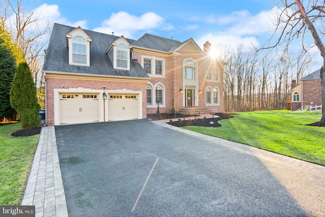 view of front facade with a garage and a front yard