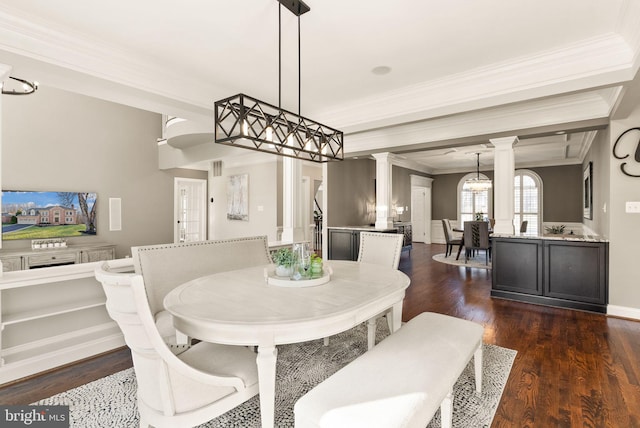 dining area with ornate columns, ornamental molding, and dark wood-type flooring