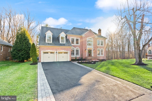 view of front of house with a garage and a front lawn