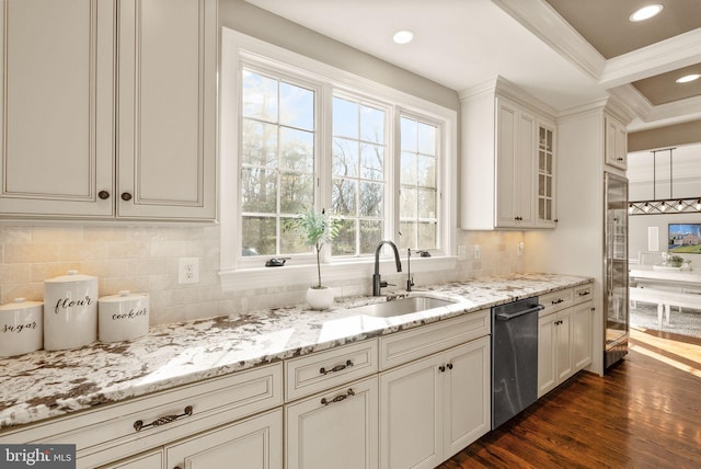 kitchen with sink, backsplash, dark hardwood / wood-style flooring, stainless steel dishwasher, and light stone countertops