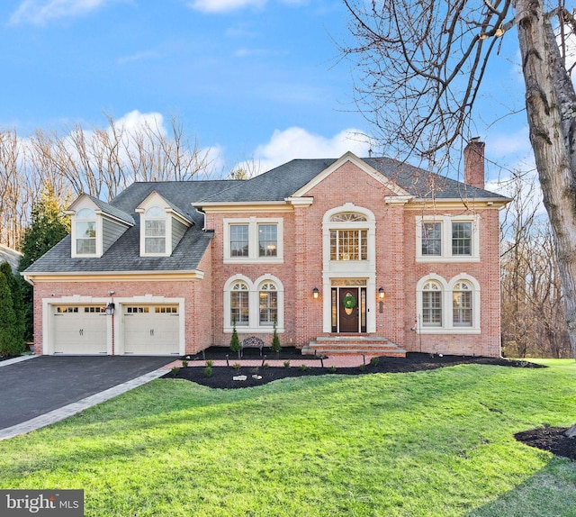 view of front of house featuring a garage and a front yard