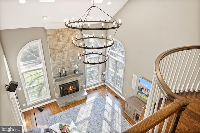 living room with a healthy amount of sunlight, dark hardwood / wood-style flooring, and high vaulted ceiling